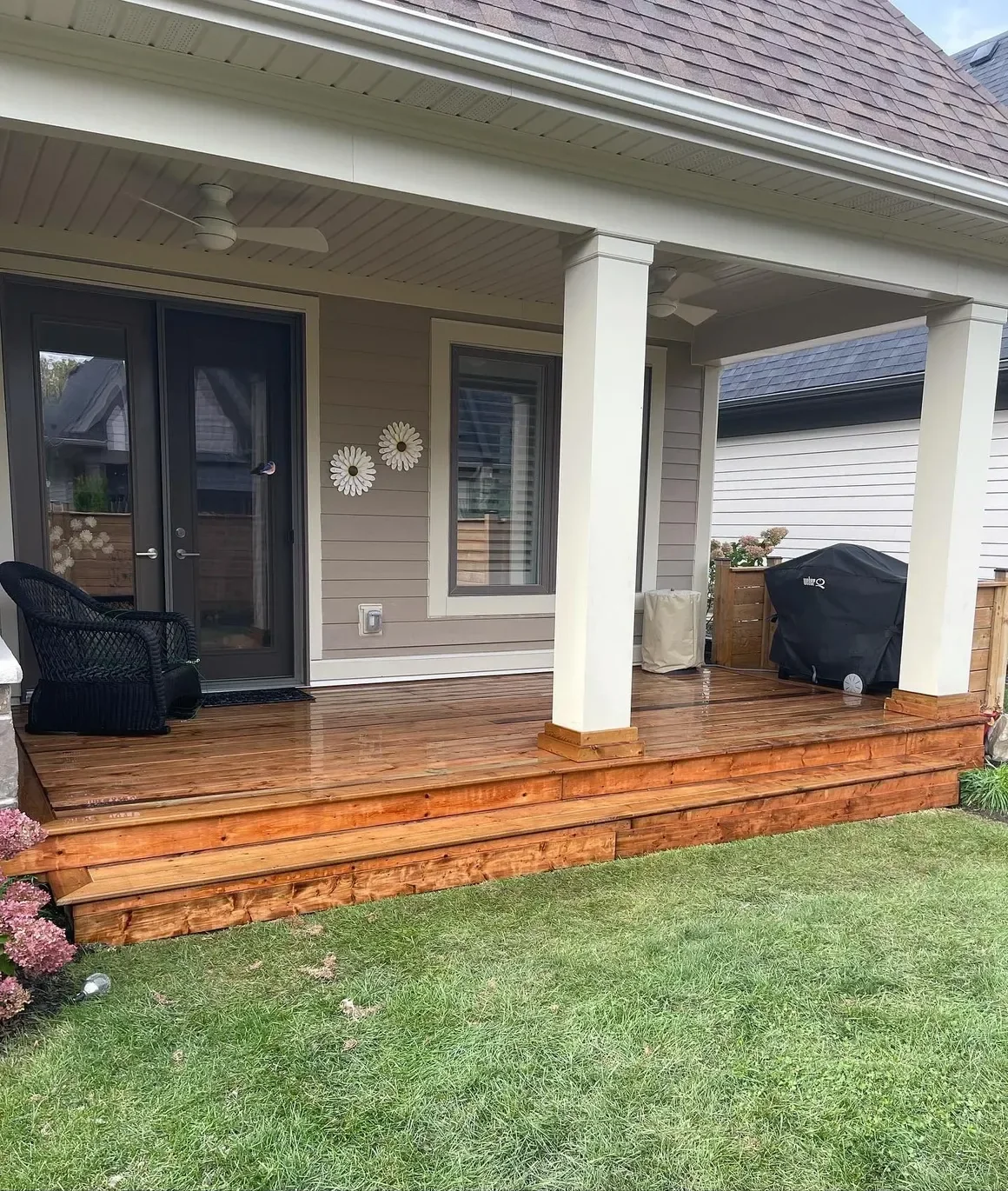 Completed covered wood porch and deck by Garden City Group