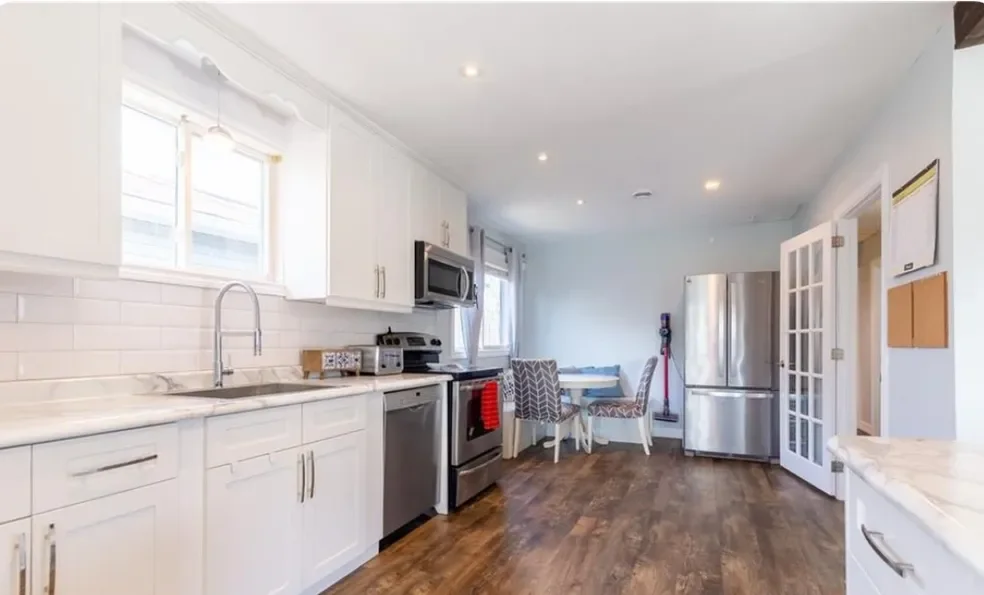 Completed bright kitchen renovation with white cabinetry