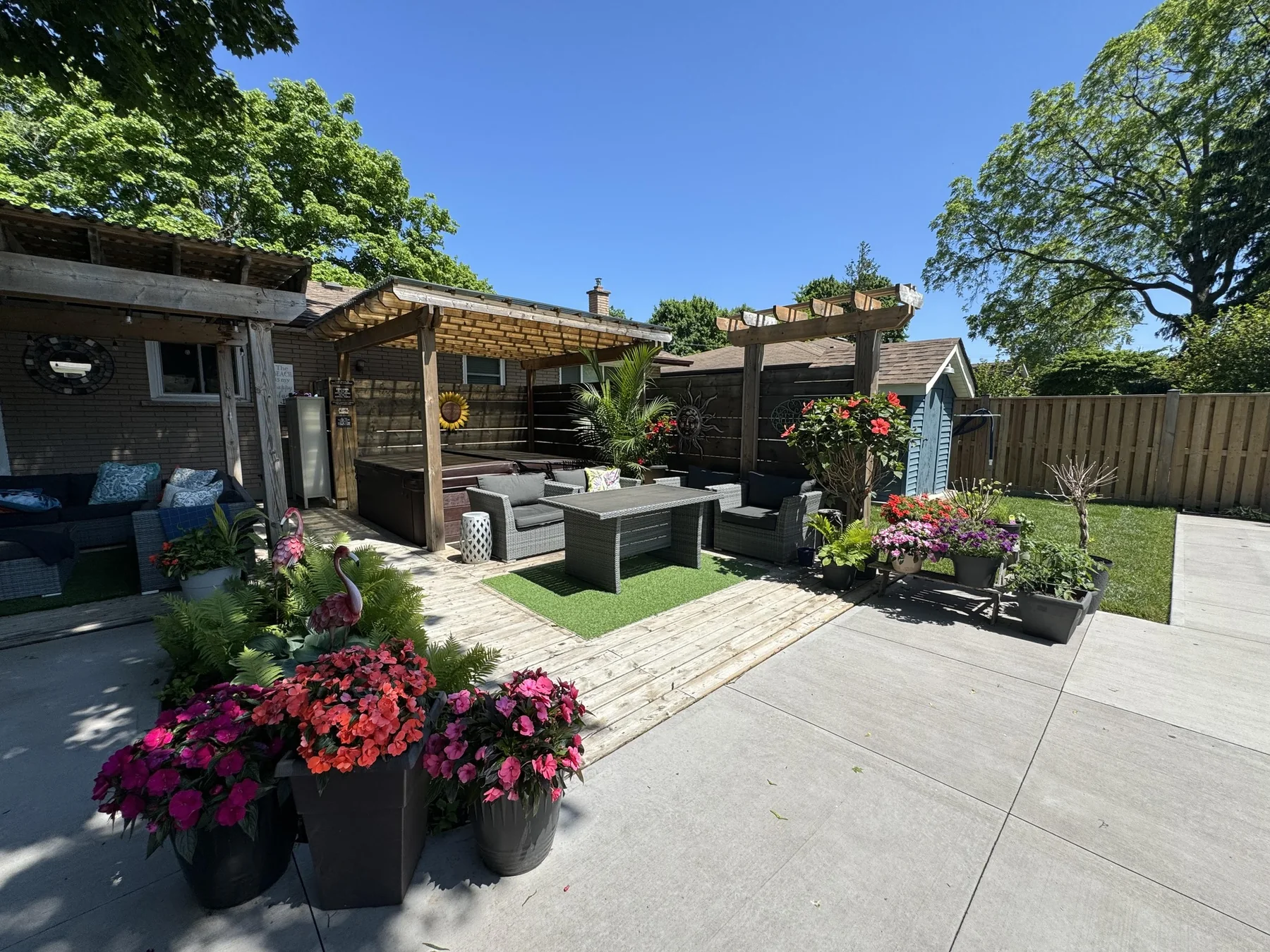 Completed outdoor living area with pergolas, deck and concrete